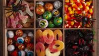 box of halloween candy and decorations in six segments